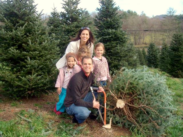 Alan and family pause for a shot next to their tree!