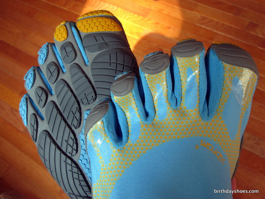 A close-up shot of the Vibram Five Fingers Bikila - the new barefoot running shoe from Vibram - showing off the front and back toe design on the sky blue, yellow, and grey Bikilas!