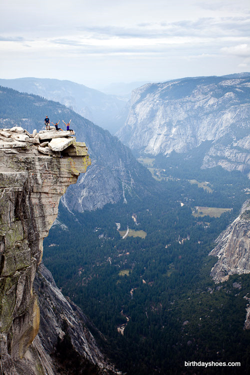 Talk about a view!  Leah sits over the edge of a cliff up the Half Dome.